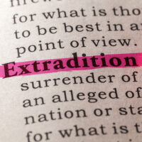 Extradition Feature Image Picture of a person in a cell awaiting extradition